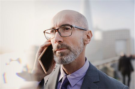 simsearch:6113-08986035,k - Close up serious businessman talking on cell phone Stock Photo - Premium Royalty-Free, Code: 6113-08986005