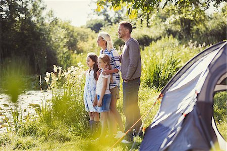 simsearch:6113-08909918,k - Family at sunny campsite lakeside looking away Photographie de stock - Premium Libres de Droits, Code: 6113-08909886
