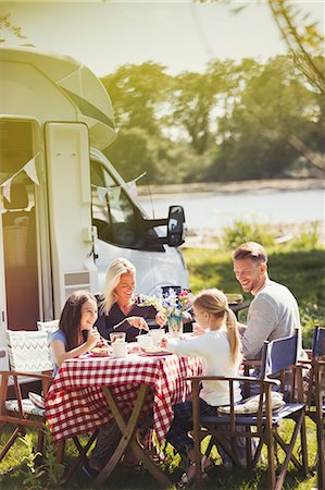 simsearch:649-09002672,k - Family enjoying breakfast at table outside sunny motor home Stock Photo - Premium Royalty-Free, Code: 6113-08909952