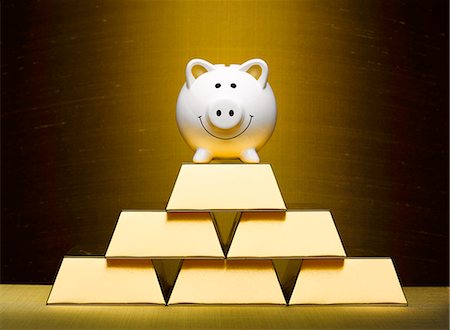 simsearch:614-00398864,k - Smiling piggy bank on top of stacked gold bars Stock Photo - Premium Royalty-Free, Code: 6113-08909968