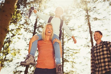 simsearch:6113-08910104,k - Mother carrying daughter on shoulders hiking in sunny woods Stock Photo - Premium Royalty-Free, Code: 6113-08909913