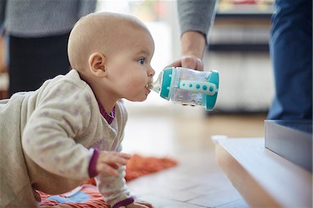 foods kids - Baby girl crawling and drinking from sip cup Stock Photo - Premium Royalty-Free, Code: 6113-08910051