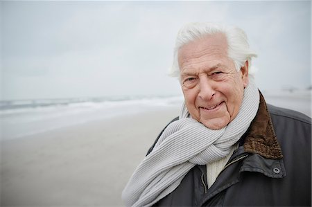 senior man portrait scarf - Portrait confident senior man wearing scarf on winter beach Stock Photo - Premium Royalty-Free, Code: 6113-08910062