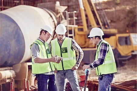 Construction workers meeting, using digital tablet at construction site Stock Photo - Premium Royalty-Free, Code: 6113-08910020
