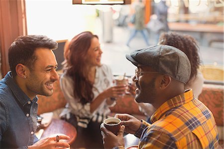 simsearch:6113-08321133,k - Friends talking and drinking coffee in cafe Stock Photo - Premium Royalty-Free, Code: 6113-08927663