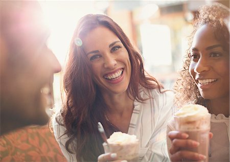 simsearch:6113-07543599,k - Portrait enthusiastic young woman drinking milkshake with friends Stock Photo - Premium Royalty-Free, Code: 6113-08927748