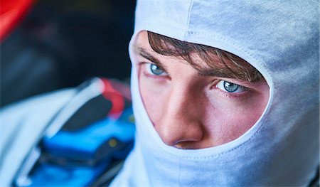 Close up serious race car driver wearing protective mask Stock Photo - Premium Royalty-Free, Code: 6113-08927786