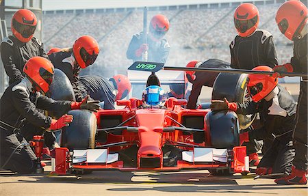 extreme sports team - Pit crew working on formula one race car in pit lane Stock Photo - Premium Royalty-Free, Code: 6113-08927813