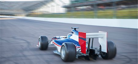 racing cars speeding - Formula one race car on sports track Stock Photo - Premium Royalty-Free, Code: 6113-08927827