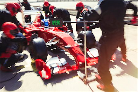 simsearch:6113-06720741,k - Pit crew replacing tires on formula one race car in pit lane Stock Photo - Premium Royalty-Free, Code: 6113-08927966