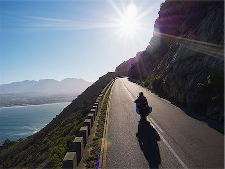 simsearch:6113-08698148,k - Couple riding motorcycle on sunny road along ocean Photographie de stock - Premium Libres de Droits, Code: 6113-08927976