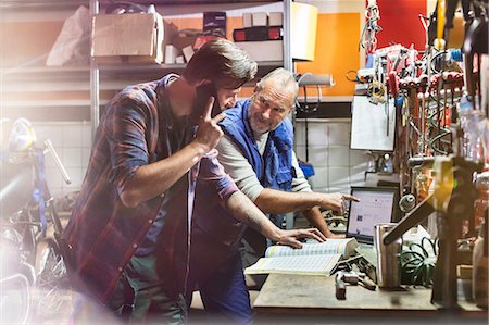 father and son workshop - Motorcycle mechanics working in workshop Stock Photo - Premium Royalty-Free, Code: 6113-08927979