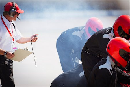 extreme sports team - Manager with stopwatch timing formula one pit crew practice session Stock Photo - Premium Royalty-Free, Code: 6113-08927900