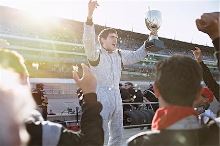 simsearch:6113-08985867,k - Formula one racing team cheering for driver with trophy, celebrating victory on sports track Stock Photo - Premium Royalty-Free, Code: 6113-08927938