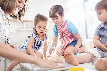 parent teaching toddler - Mother and children baking in kitchen Stock Photo - Premium Royalty-Free, Code: 6113-08928054