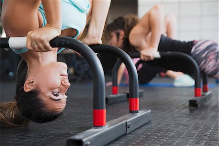 simsearch:649-03418201,k - Focused young woman doing upside-down shoulder stand with equipment at gym Photographie de stock - Premium Libres de Droits, Code: 6113-09058290