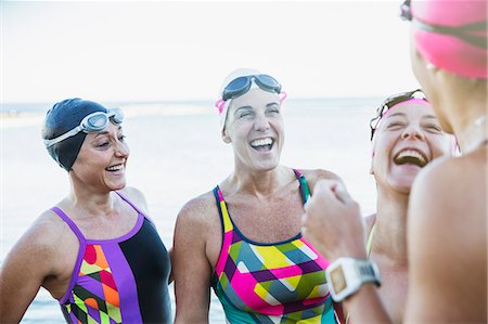 simsearch:6113-09058376,k - Laughing female open water swimmers talking Stock Photo - Premium Royalty-Free, Code: 6113-09058385