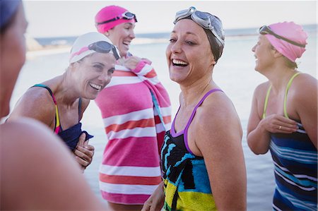 simsearch:6113-09058376,k - Laughing female open water swimmers drying off with towels Stock Photo - Premium Royalty-Free, Code: 6113-09058316