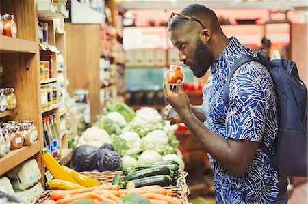 simsearch:6113-09058557,k - Man shopping, smelling spices in grocery store Stock Photo - Premium Royalty-Free, Code: 6113-09058458