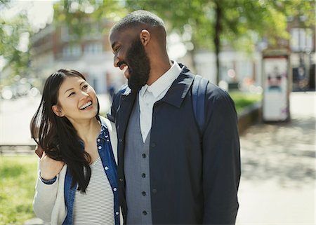 simsearch:614-06623552,k - Affectionate couple laughing in sunny urban park Foto de stock - Sin royalties Premium, Código: 6113-09058546