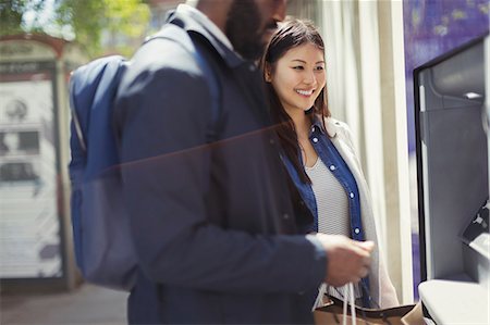 Young couple using ATM Stock Photo - Premium Royalty-Free, Code: 6113-09058618