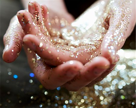 Close up hands cupping gold glitter Stock Photo - Premium Royalty-Free, Code: 6113-09058751