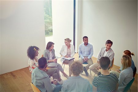 People talking in a circle in group therapy session Stock Photo - Premium Royalty-Free, Code: 6113-09058770