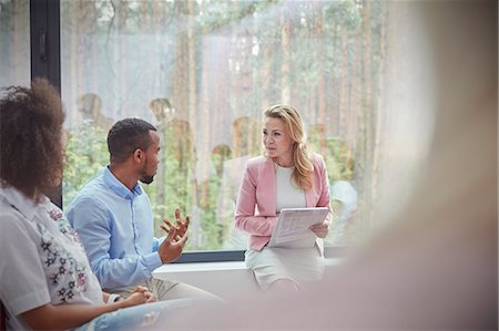 Therapist listening to man talking in group therapy session Stock Photo - Premium Royalty-Free, Code: 6113-09058792