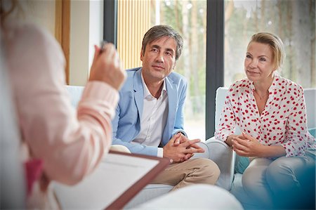 simsearch:6113-09058760,k - Couple listening to therapist in couples therapy counseling session Stock Photo - Premium Royalty-Free, Code: 6113-09058794