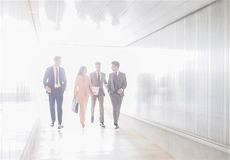 simsearch:6113-09058702,k - Business people talking and walking in office corridor Stock Photo - Premium Royalty-Free, Code: 6113-09058855