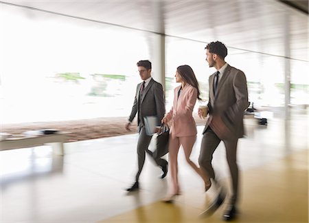 simsearch:6113-09058702,k - Business people walking and talking in office corridor Stock Photo - Premium Royalty-Free, Code: 6113-09058862