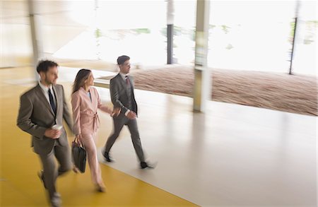 simsearch:6113-09058702,k - Business people walking in office lobby Stock Photo - Premium Royalty-Free, Code: 6113-09058871