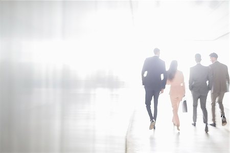 simsearch:6113-09058702,k - Business people walking in sunny office corridor Stock Photo - Premium Royalty-Free, Code: 6113-09058891