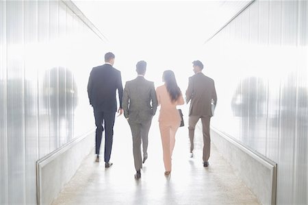 simsearch:6113-09058929,k - Business people walking in illuminated office corridor Foto de stock - Sin royalties Premium, Código: 6113-09058950