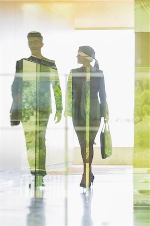 Silhouette business people walking in office corridor Stock Photo - Premium Royalty-Free, Code: 6113-09058907