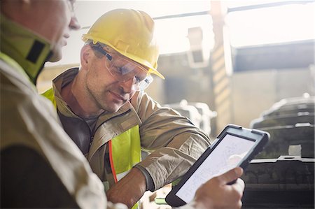 protective workwear - Steelworkers using digital tablet in steel mill Stock Photo - Premium Royalty-Free, Code: 6113-09059054