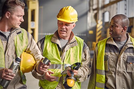 Steelworkers with insulated drink container taking coffee break in steel mill Stock Photo - Premium Royalty-Free, Code: 6113-09059059