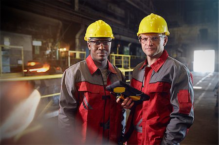 Portrait confident steelworkers with digital tablet in steel mill Stock Photo - Premium Royalty-Free, Code: 6113-09059064