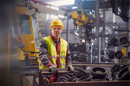 selective focus portrait - Portrait serious, confident steelworker in steel mill Stock Photo - Premium Royalty-Free, Code: 6113-09059083