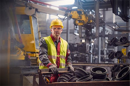 portrait, adult - Portrait serious, confident steelworker in steel mill Stock Photo - Premium Royalty-Free, Code: 6113-09059083