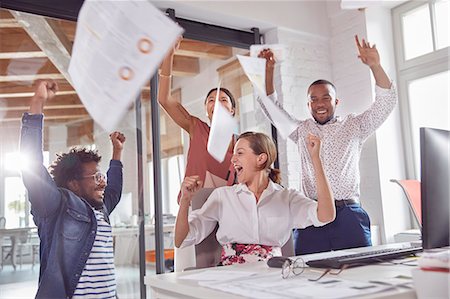 simsearch:6113-07243067,k - Exuberant business people celebrating, throwing paperwork overhead in office Stock Photo - Premium Royalty-Free, Code: 6113-09059011