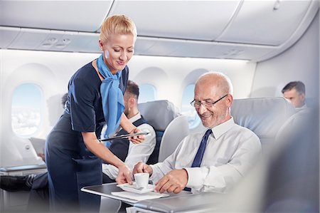 flight attendant serving espresso coffee to businessman in first class on airplane Photographie de stock - Premium Libres de Droits, Code: 6113-09059168