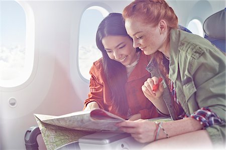 same sex couple (female) - Young women friends looking at map on airplane Stock Photo - Premium Royalty-Free, Code: 6113-09059191