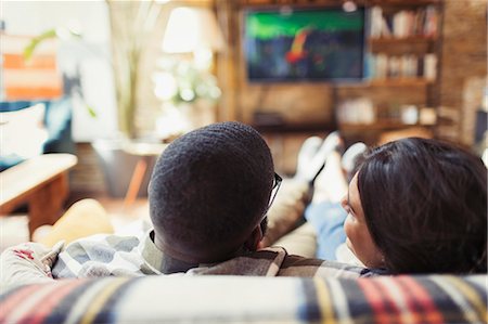 simsearch:614-06898605,k - Young couple relaxing, watching TV on living room sofa Stock Photo - Premium Royalty-Free, Code: 6113-09059248