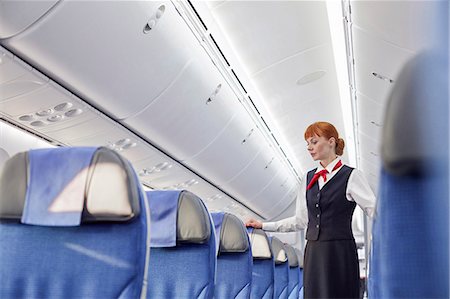 simsearch:6113-09059160,k - Female flight attendant on empty airplane Photographie de stock - Premium Libres de Droits, Code: 6113-09059207