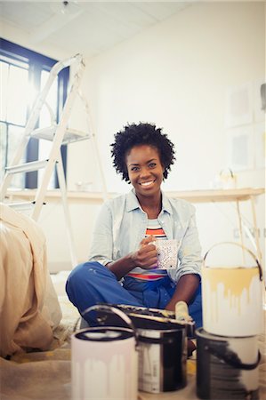 self sufficient - Portrait smiling woman drinking coffee, painting living room Stock Photo - Premium Royalty-Free, Code: 6113-09059371