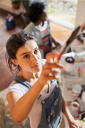 Young woman painting overalls Stock Photos Page 1 Masterfile