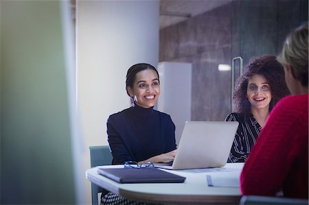 simsearch:6124-09269855,k - Smiling businesswomen working in conference room meeting Stock Photo - Premium Royalty-Free, Code: 6113-09004971