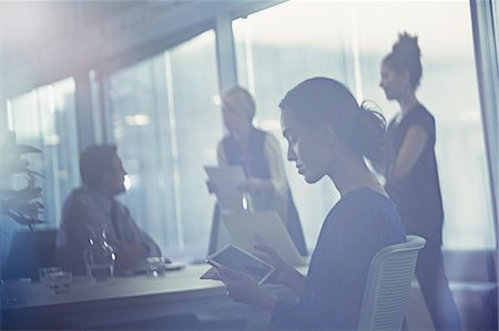 simsearch:6113-07242679,k - Businesswoman using digital tablet in conference room meeting Photographie de stock - Premium Libres de Droits, Code: 6113-09004924