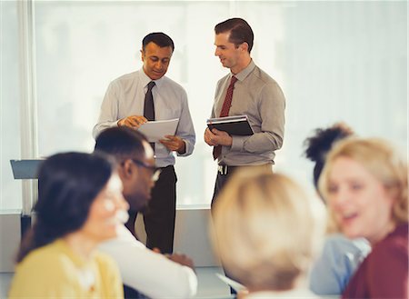 simsearch:649-07520125,k - Businessmen discussing paperwork at conference Foto de stock - Sin royalties Premium, Código: 6113-09005051